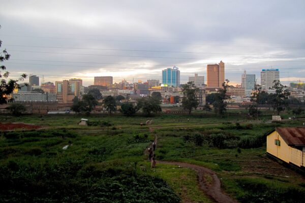 Uganda explained 2026 — the Kampala skyline seen across green open ground at dusk