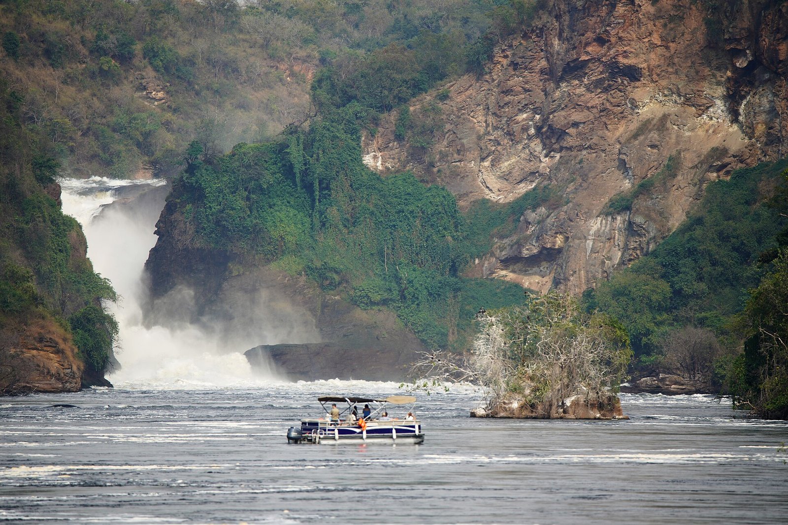 Uganda explained 2026 — a tourist boat below Murchison Falls on the Victoria Nile