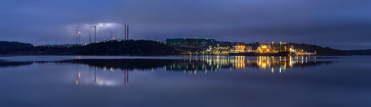 An oil refinery lit at dusk