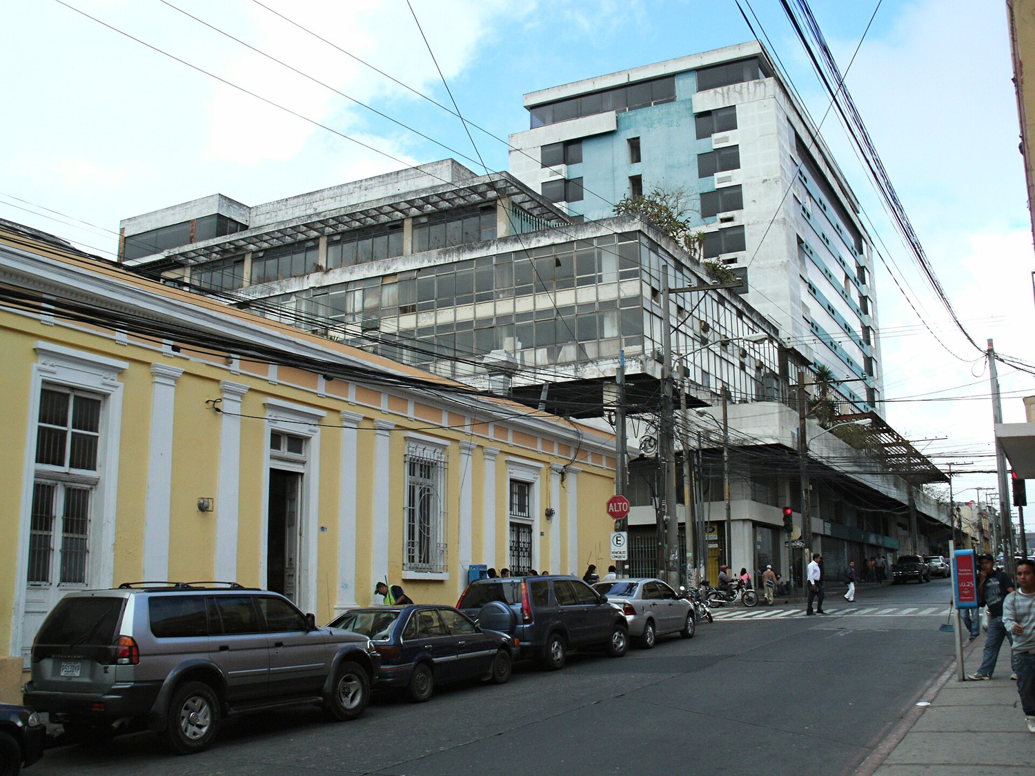 A street in Zone 1 of Guatemala City with low colonial buildings and parked cars