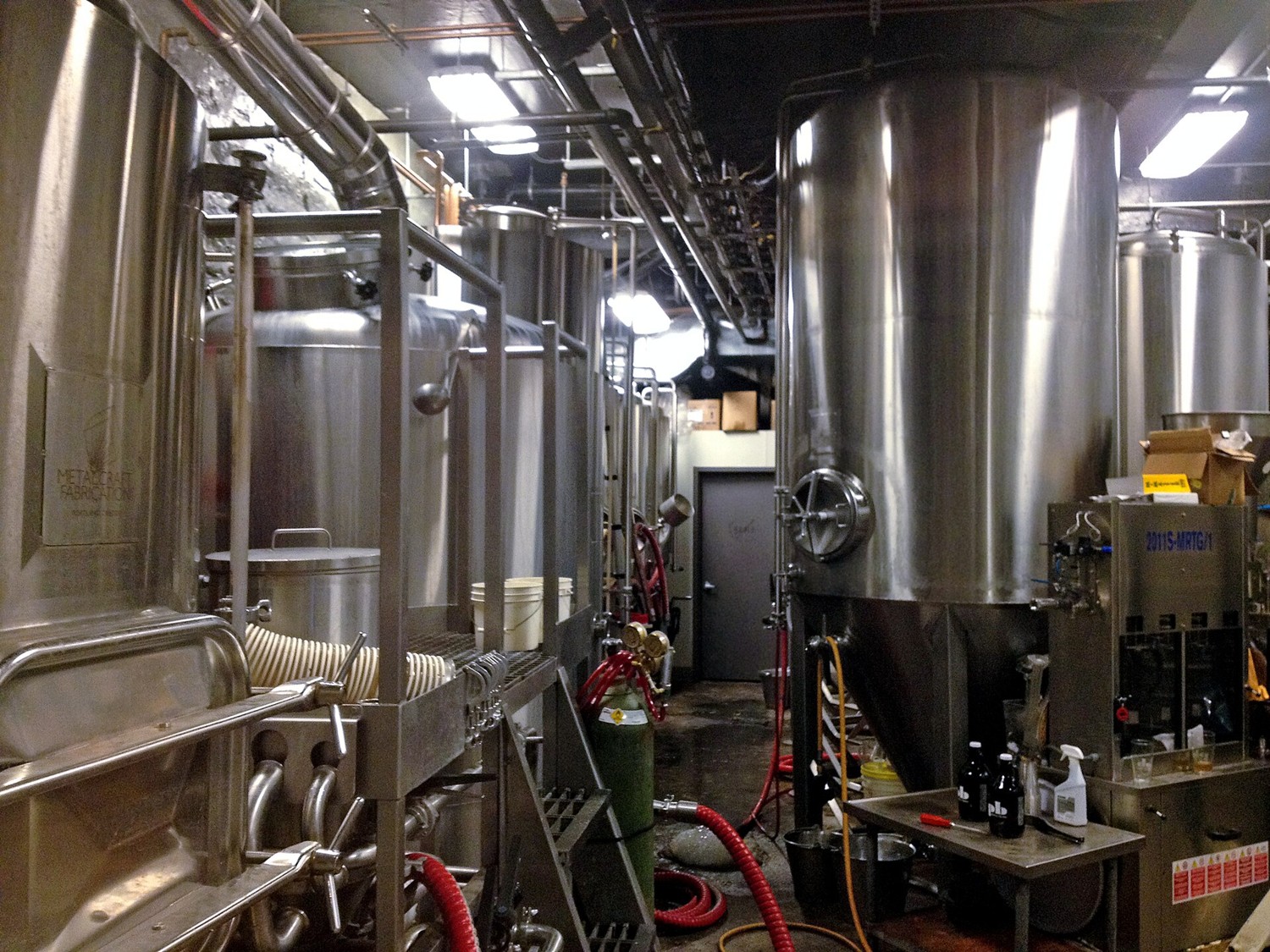 Stainless steel fermentation tanks inside a brewery