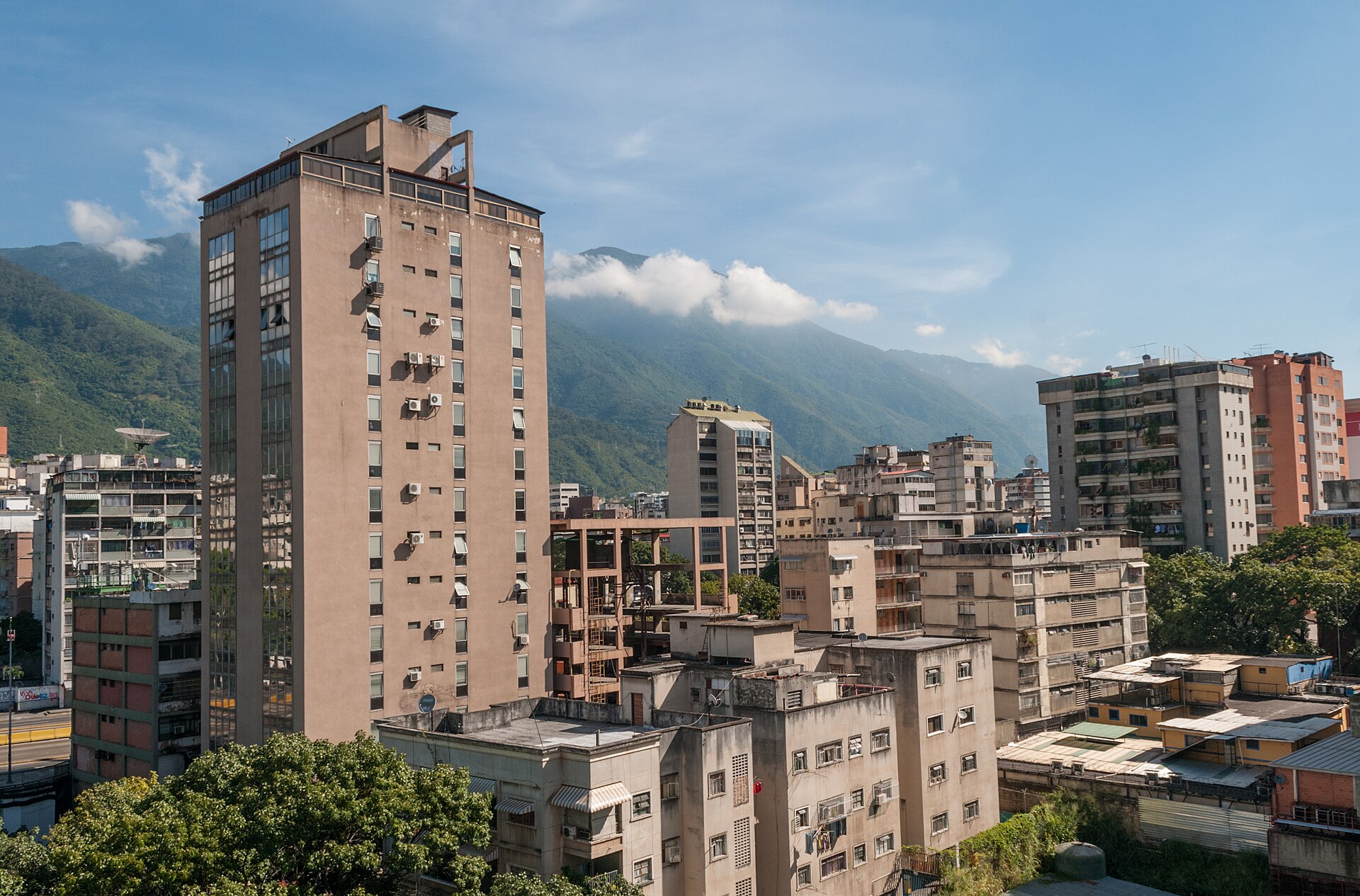 Venezuela explained 2026 — residential towers in Caracas beneath the Ávila mountain