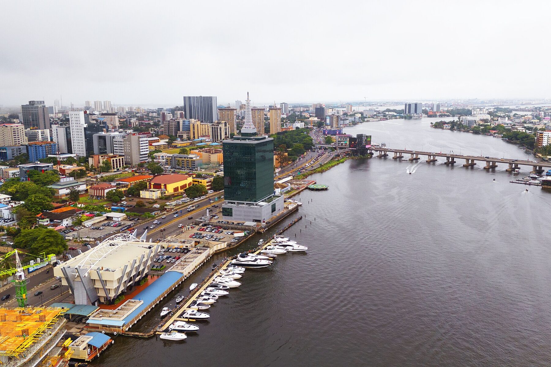 Aerial view of Victoria Island in Lagos, with office towers, the lagoon, a marina full of boats and a bridge to Ikoyi.