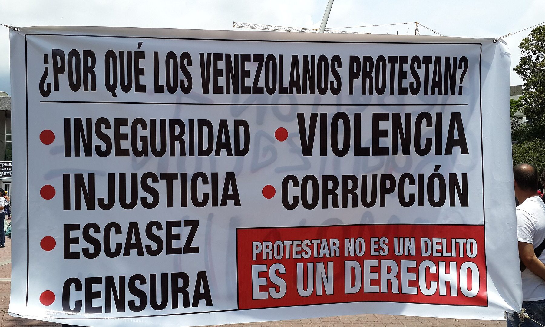 A protest banner in Venezuela listing insecurity, violence, injustice, corruption, scarcity and censorship
