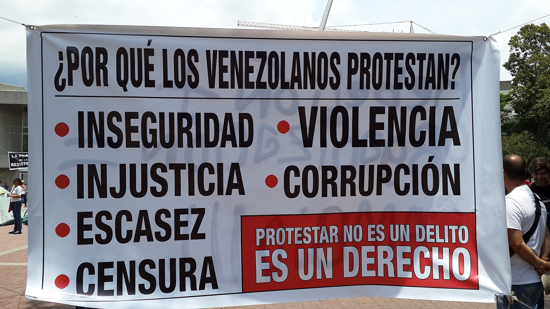 A protest banner in Venezuela listing insecurity, violence, injustice, corruption, scarcity and censorship