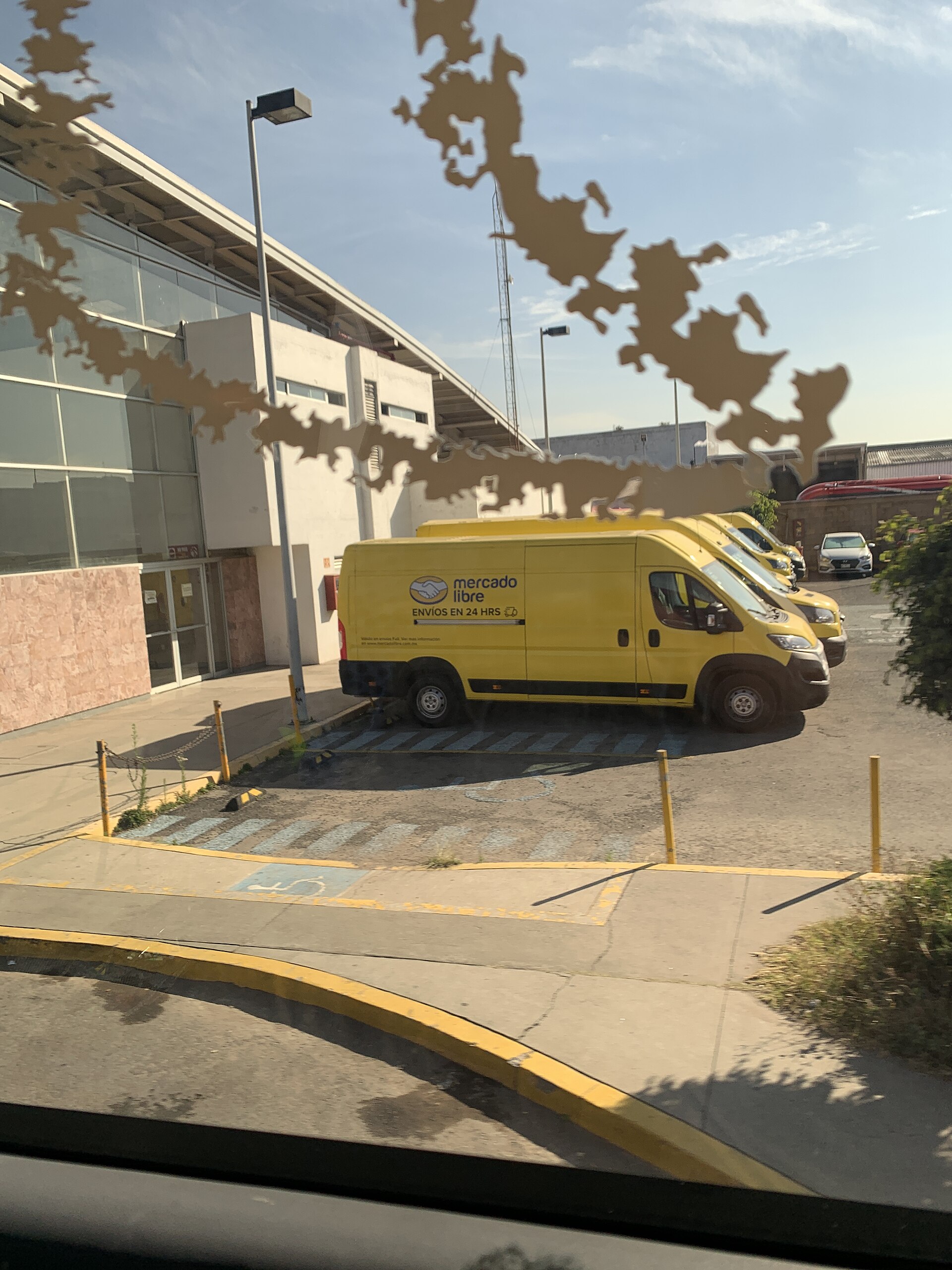 Mercado Libre in Mexico — yellow Mercado Libre delivery vans parked in Tlalnepantla