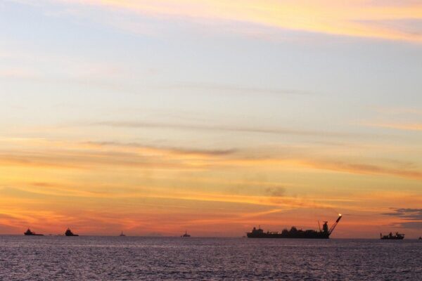 What is Petrobras: an oil production ship (FPSO) in the Campos Basin off Rio de Janeiro at sunset