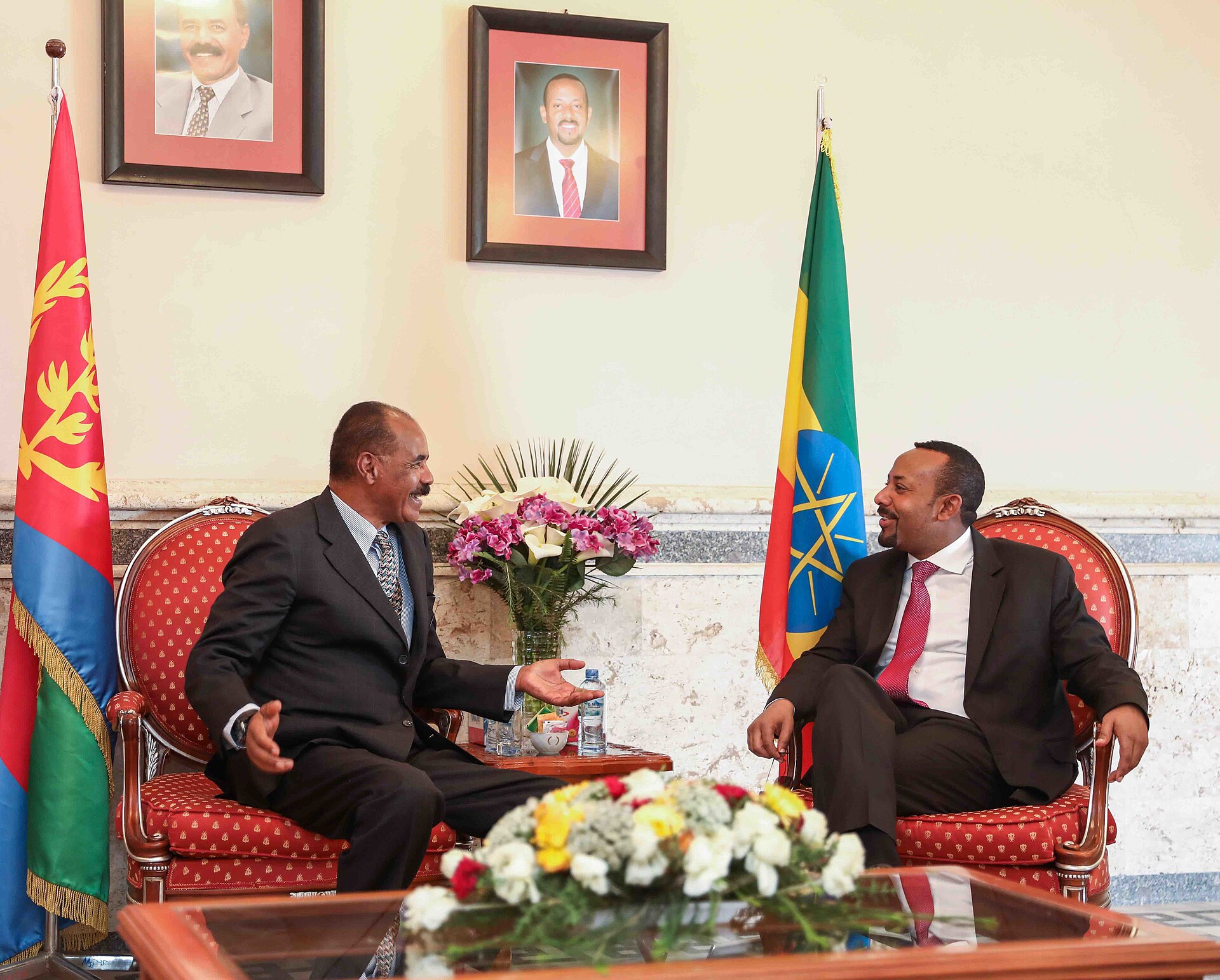 Ethiopian Prime Minister Abiy Ahmed and Eritrean President Isaias Afwerki talking in armchairs in March 2019
