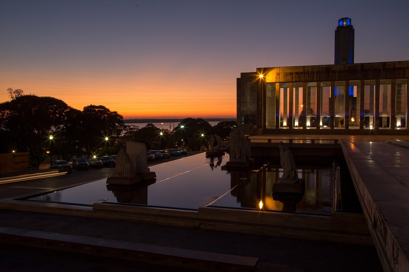 The Monumento a la Bandera in Rosario, Argentina, lit at dawn above the Parana river.
