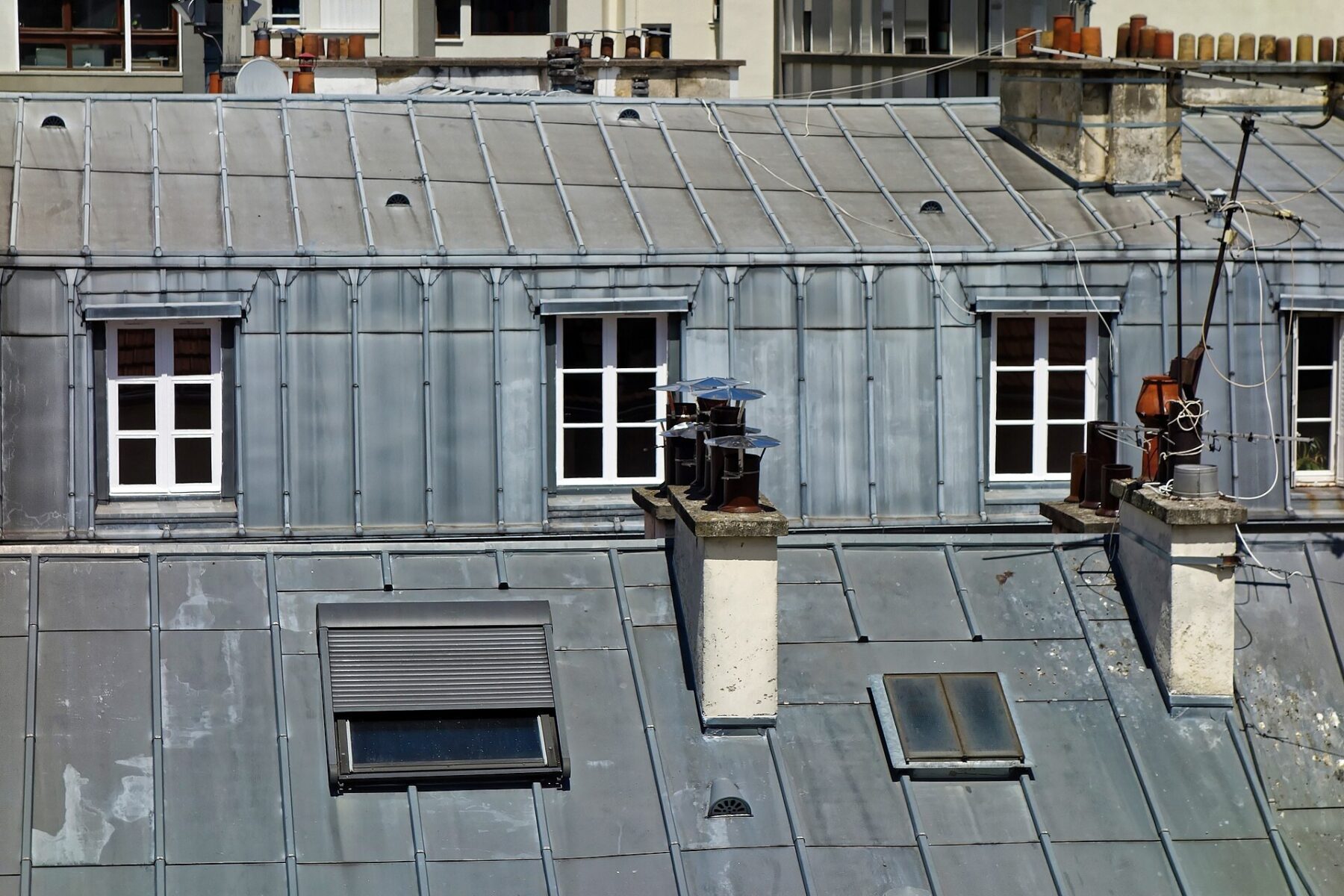 Grey zinc-clad rooftops with dormer windows in Paris