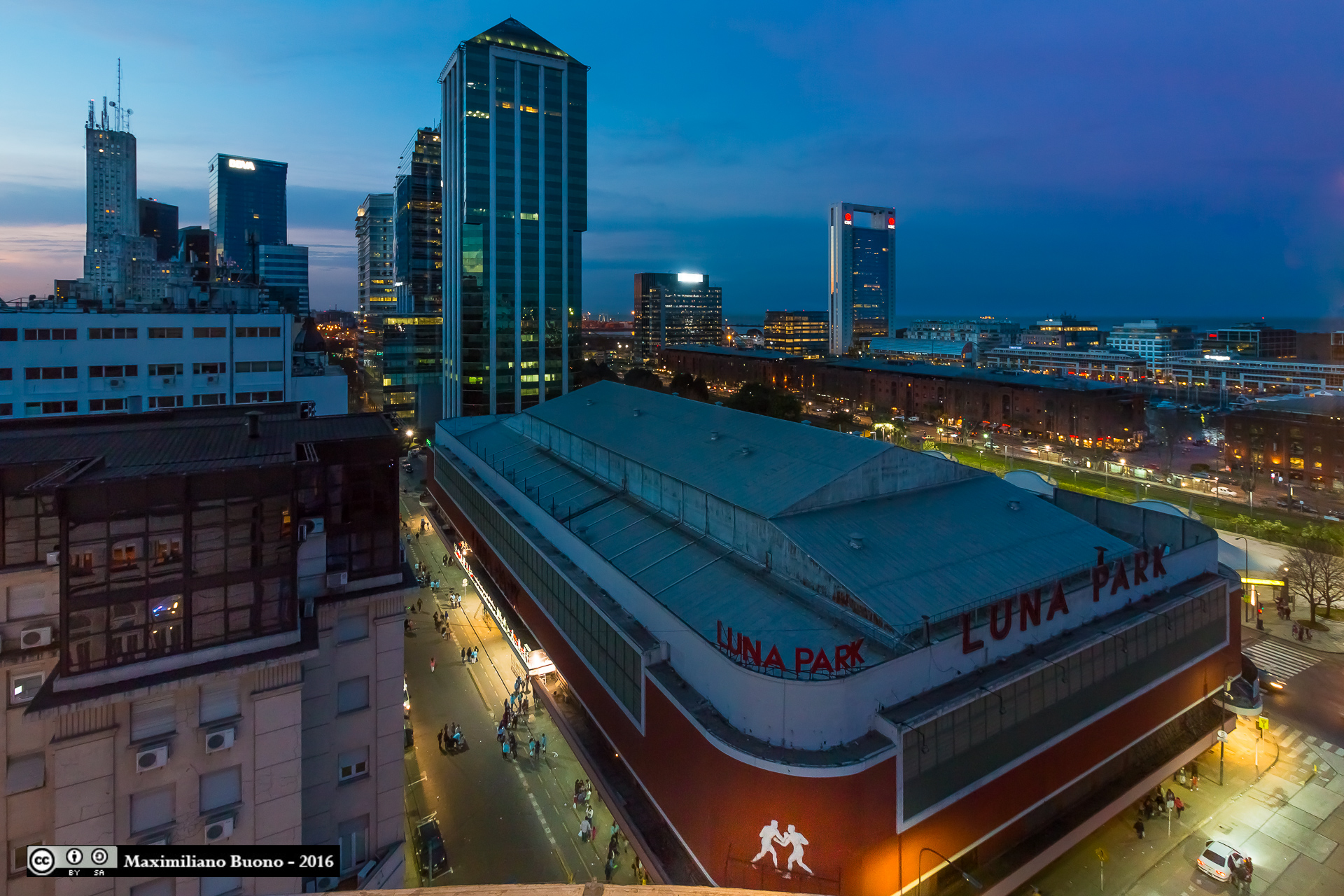 Luna Park arena at dusk with Buenos Aires skyscrapers behind
