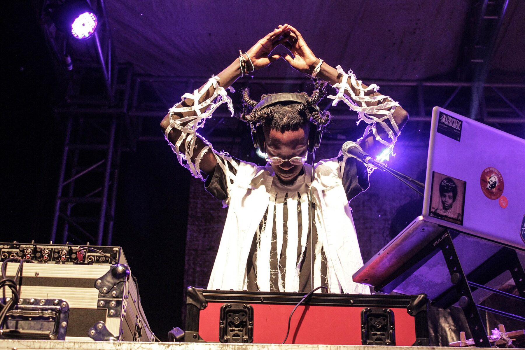 Senegalese artist Ibaaku performing a DJ set on stage in Jinja, Uganda