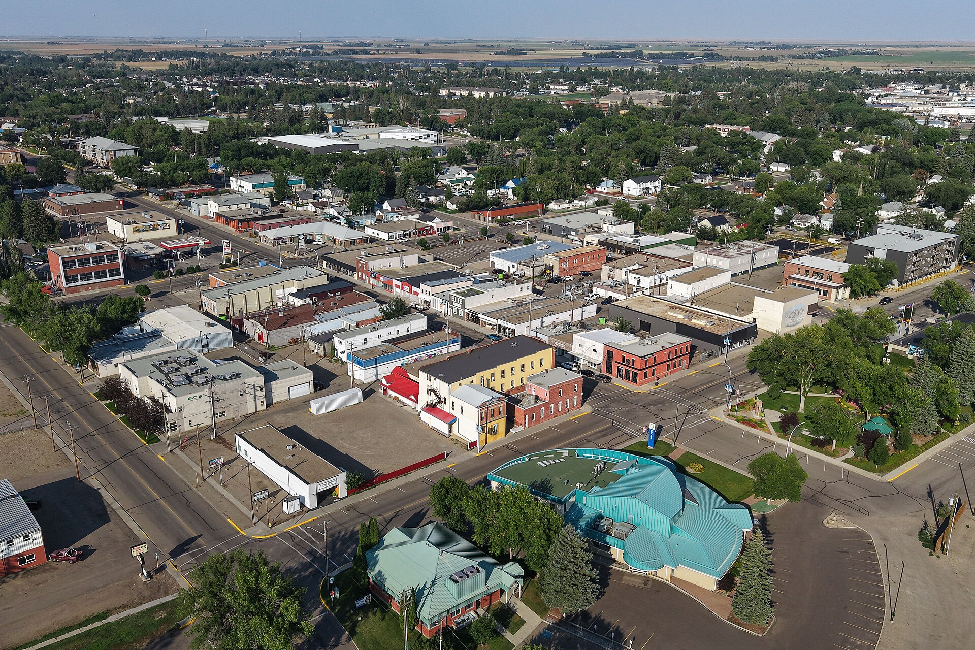 Aerial view of Brooks, a small city in southeastern Alberta, with tree-lined streets and low buildings.
