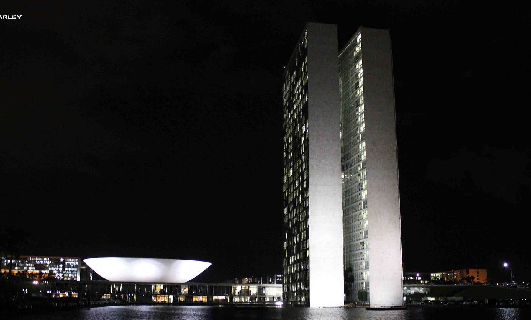 Brazil's National Congress towers and bowl-shaped Senate dome in Brasília lit at night