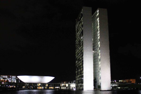 Brazil's National Congress towers and bowl-shaped Senate dome in Brasília lit at night
