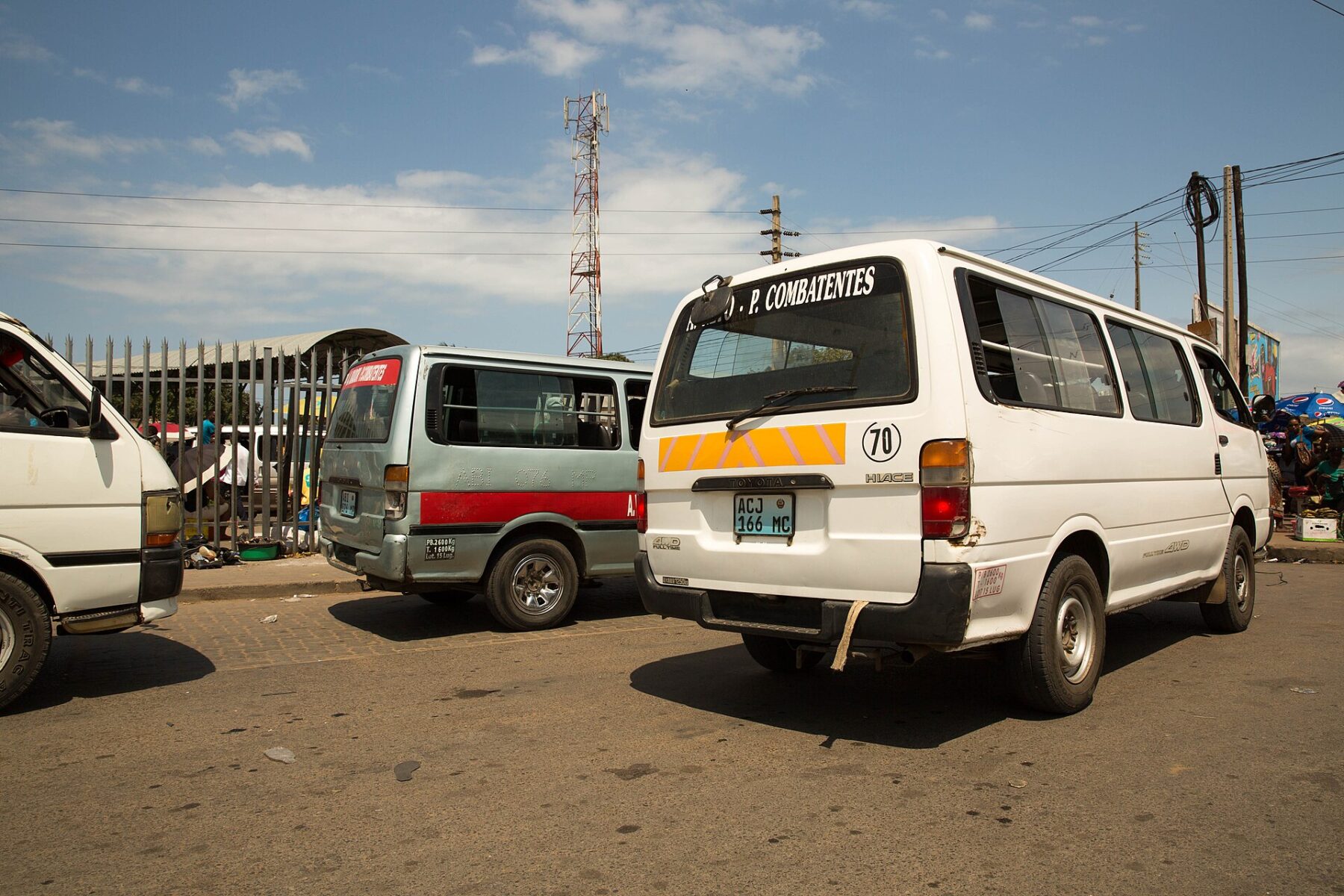 White minibus taxis known as chapas parked at a terminal in Maputo, Mozambique