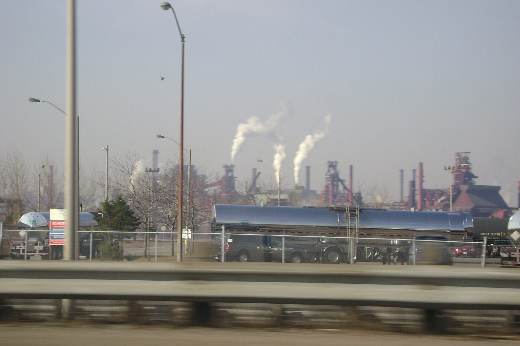 Smoking steel mill stacks seen from a highway in Hamilton, Ontario.
