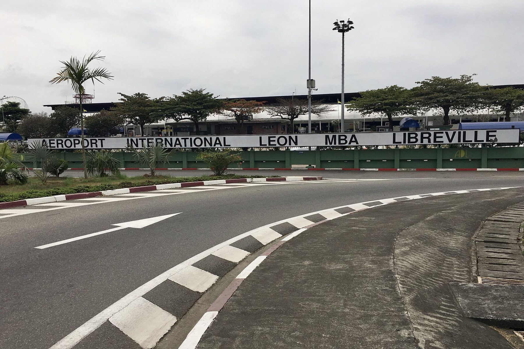 Entrance sign of Léon-Mba International Airport in Libreville, Gabon, beside the access road