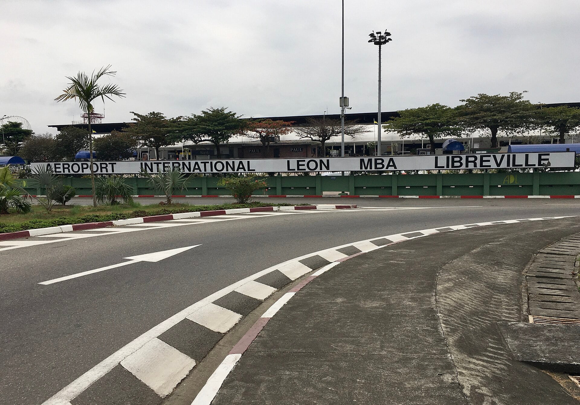 Entrance sign of Léon-Mba International Airport in Libreville, Gabon, beside the access road
