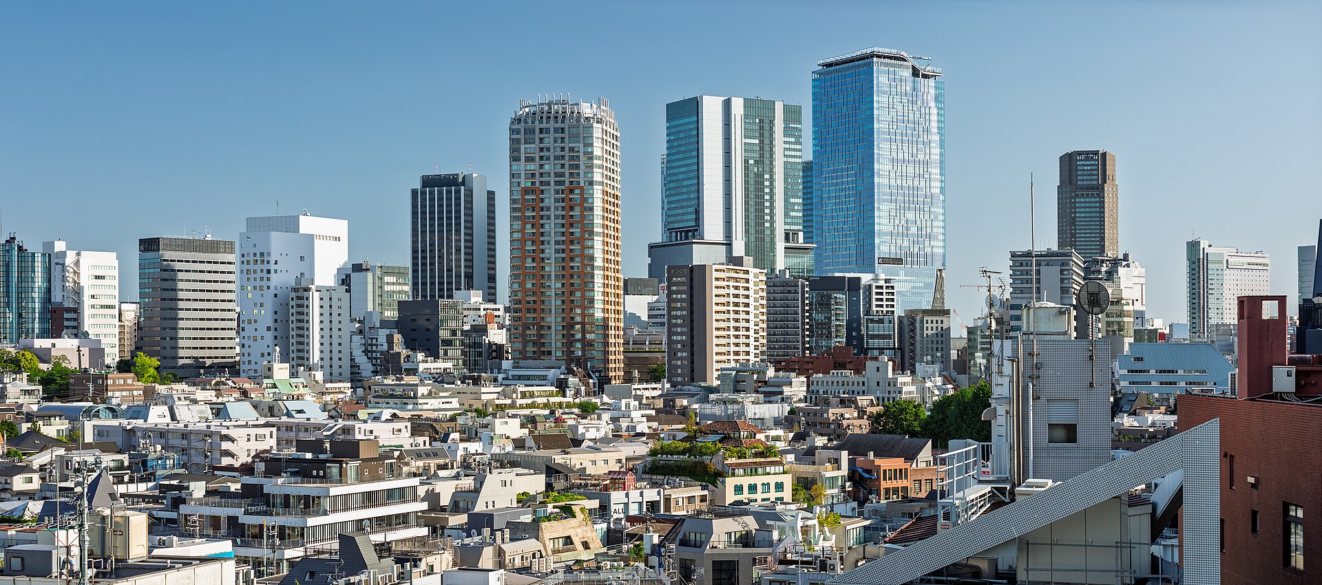 Shibuya skyline of high-rise towers seen from a rooftop garden in Omotesando, Tokyo.