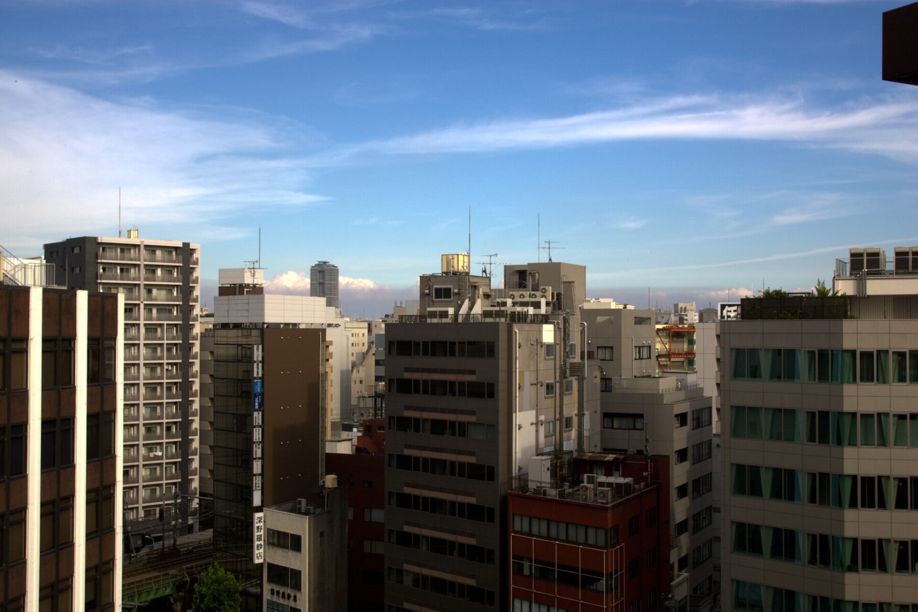 Apartment and office buildings under a blue sky in Ueno, Tokyo, Japan