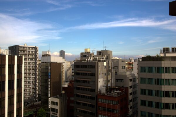 Apartment and office buildings under a blue sky in Ueno, Tokyo, Japan