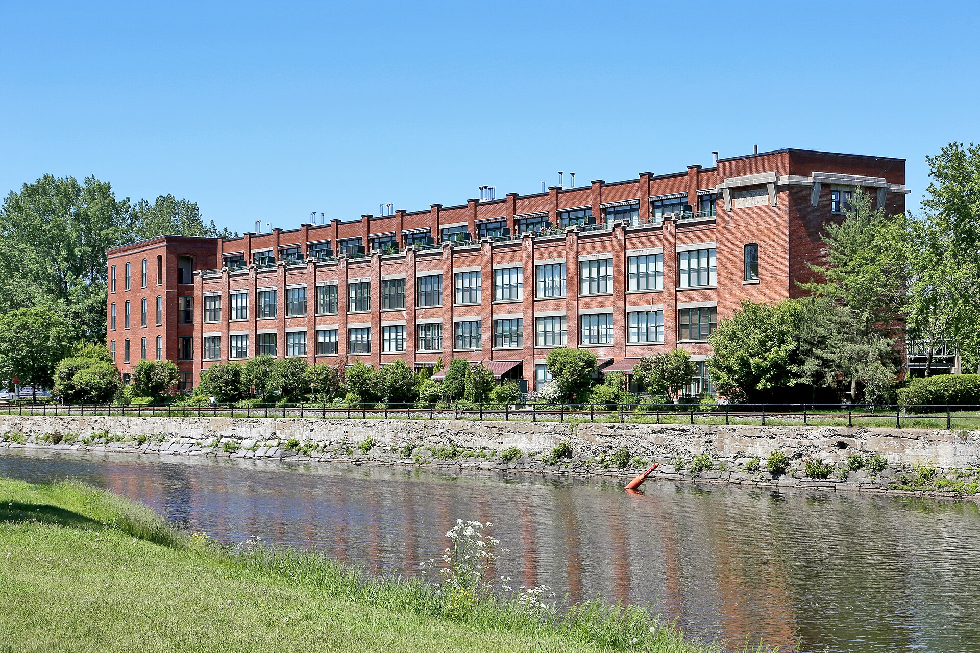 Red-brick Steel Company of Canada (Stelco) rolling mill building beside a waterway in Montreal.
