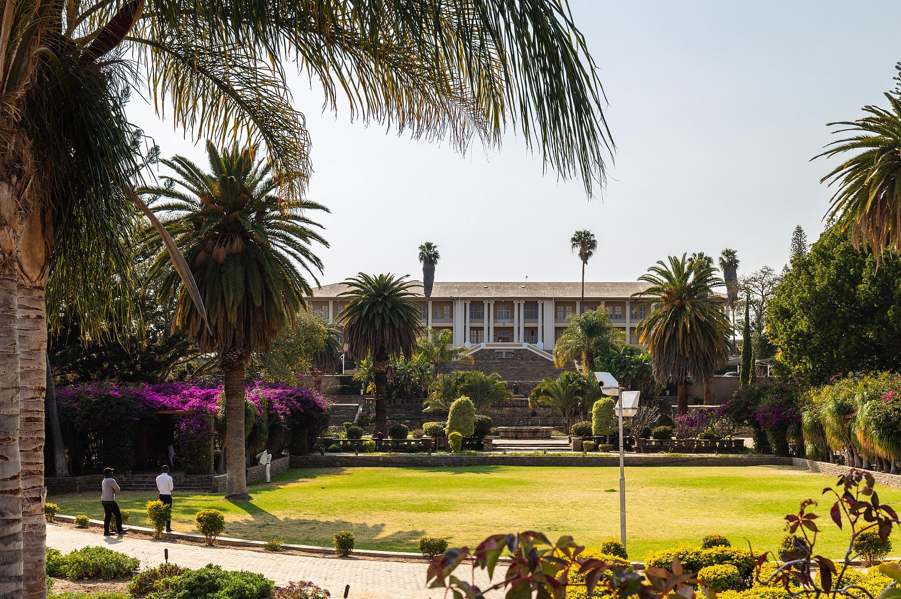 Tintenpalast, the seat of Namibia's parliament in Windhoek, behind a garden with palm trees