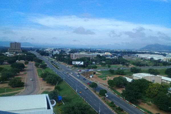 Aerial view of a multi-lane road and government buildings in Gaborone, Botswana, with hills on the horizon