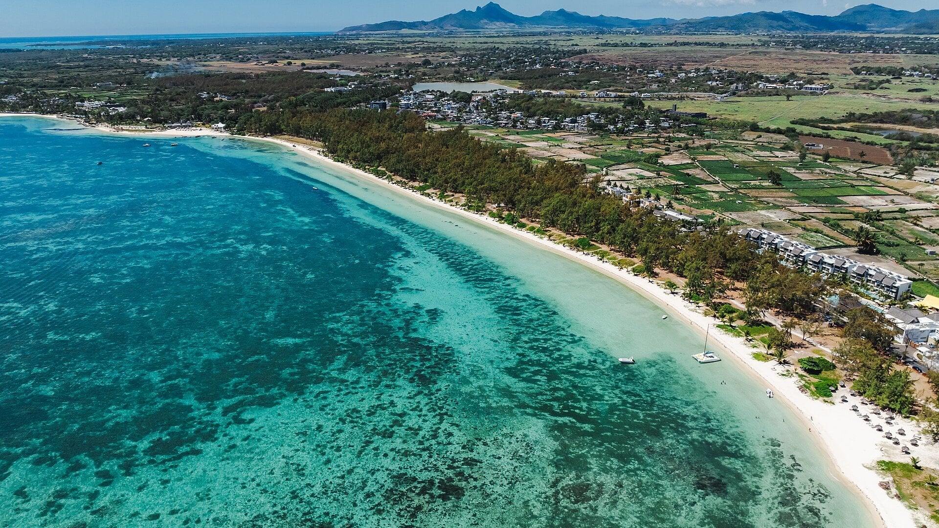 Aerial view of the white sand beach and turquoise lagoon at Belle Mare on the east coast of Mauritius