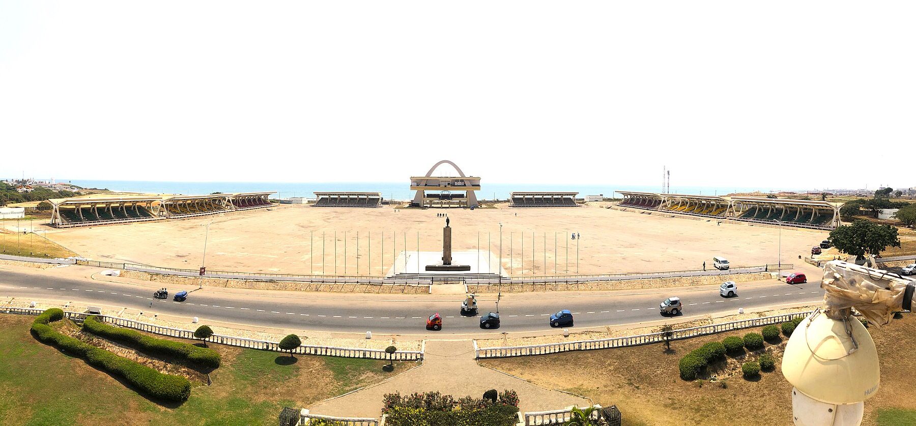 Wide view of Black Star Square in Accra, with the independence arch at the centre of a large open parade ground and the sea behind