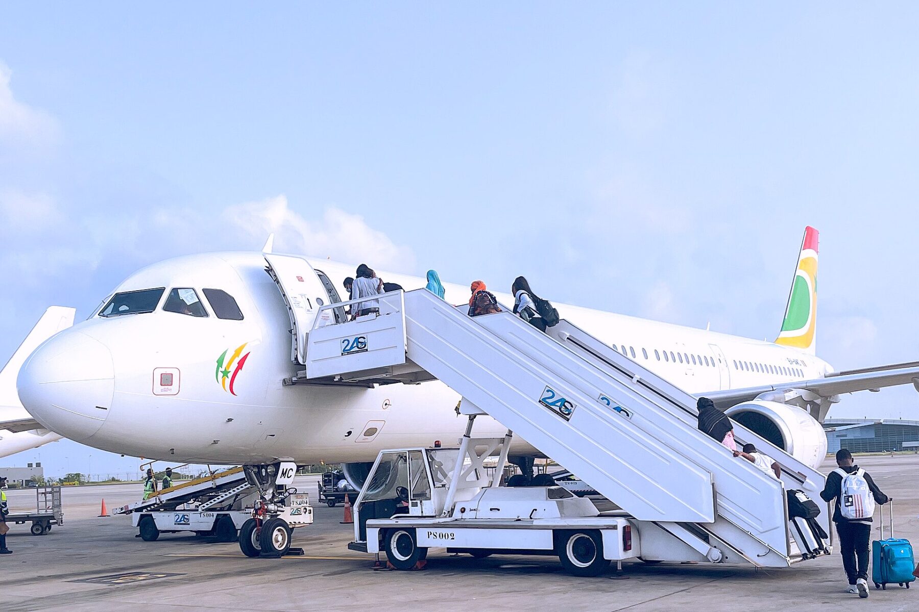 Passengers boarding an Air Sénégal Airbus by stairs at Blaise Diagne International Airport near Dakar, Senegal