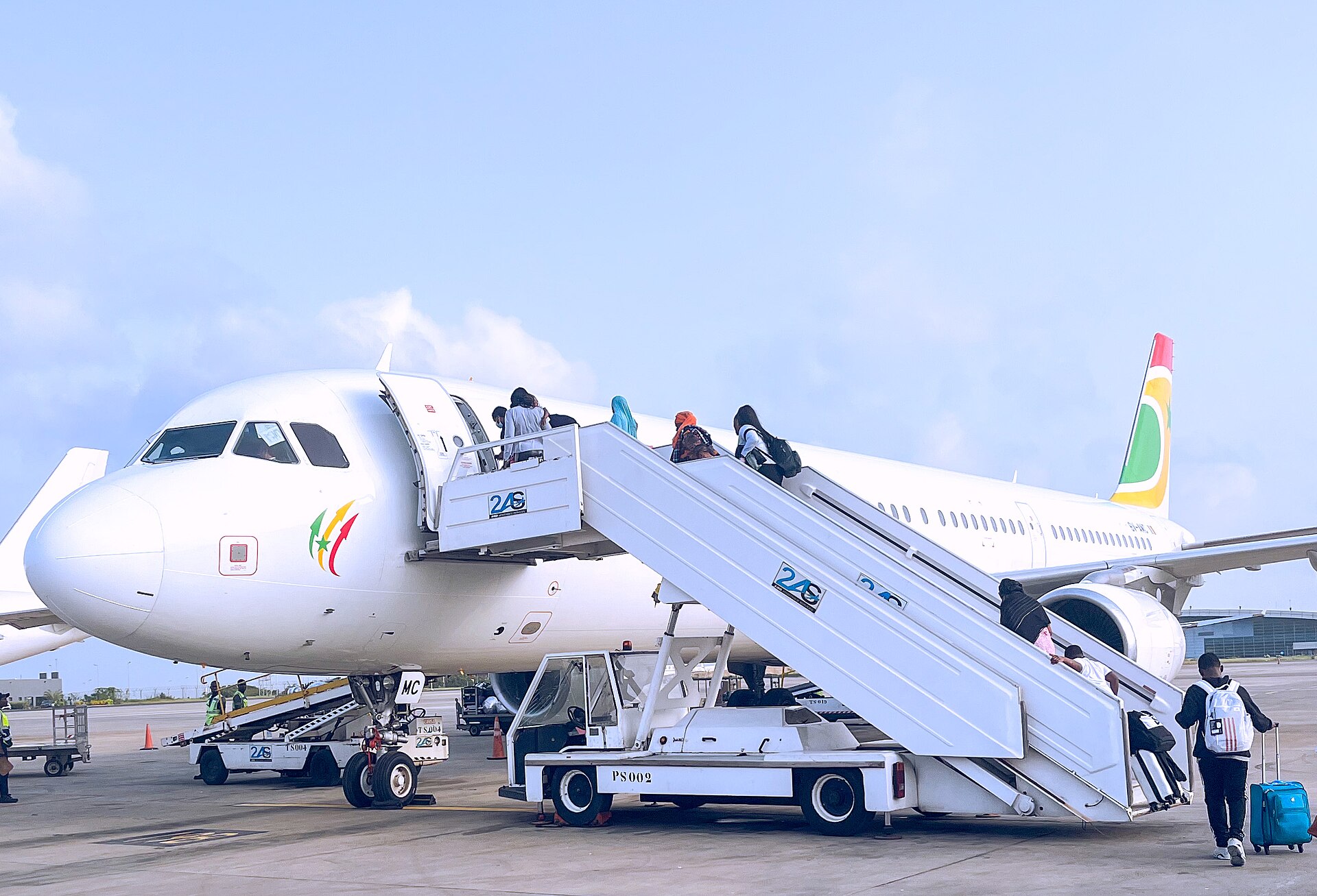 Passengers boarding an Air Sénégal Airbus by stairs at Blaise Diagne International Airport near Dakar, Senegal