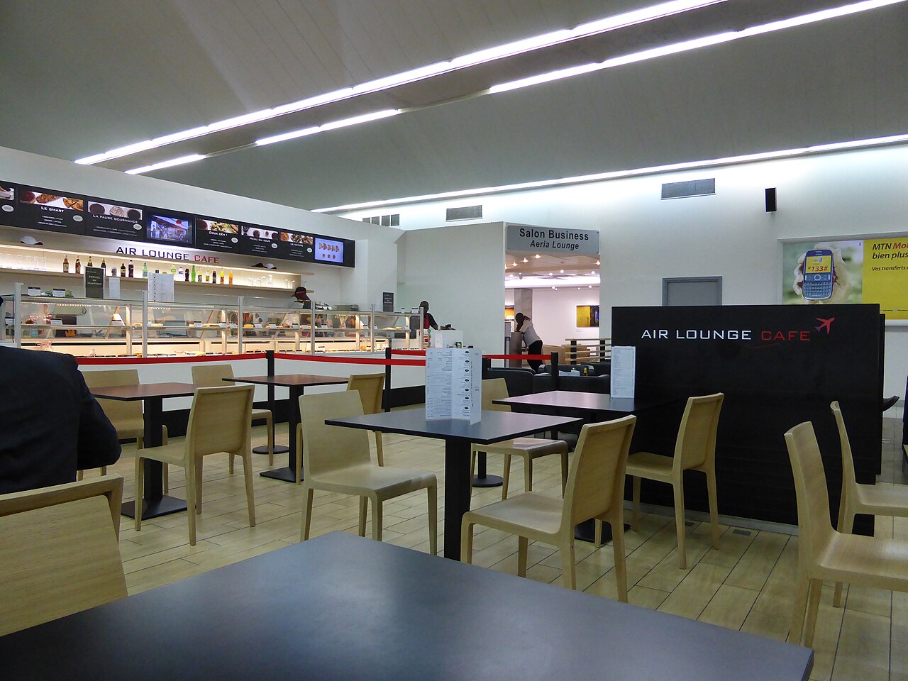 Air Lounge Café and a business lounge sign in the departure hall of Abidjan airport