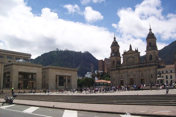 Plaza de Bolívar in central Bogotá with the Palace of Justice at left, the cathedral at right and a green mountain behind