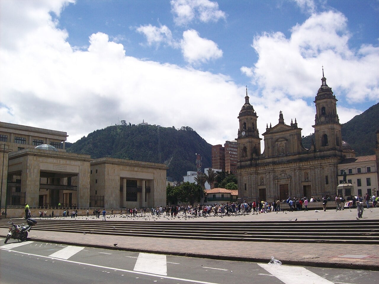 Plaza de Bolívar in central Bogotá with the Palace of Justice at left, the cathedral at right and a green mountain behind