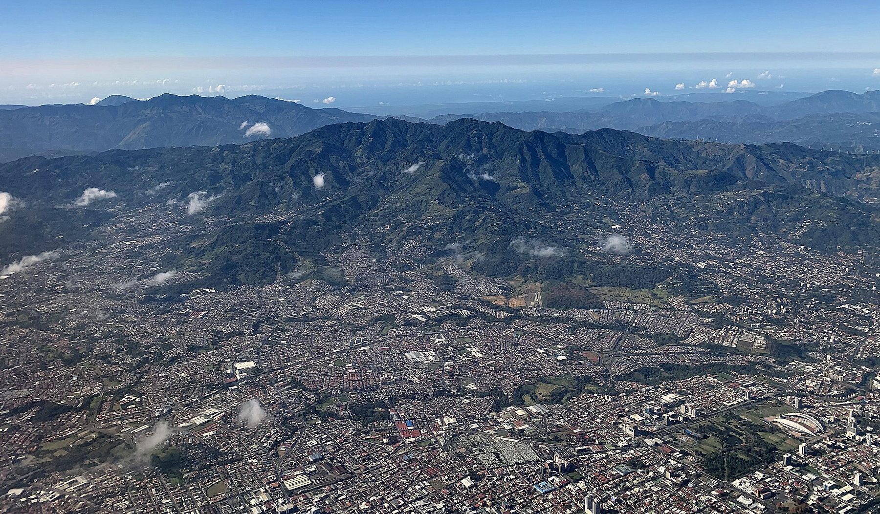 Aerial view of the San José metropolitan area in Costa Rica, with La Sabana park and the Central Valley hills beyond