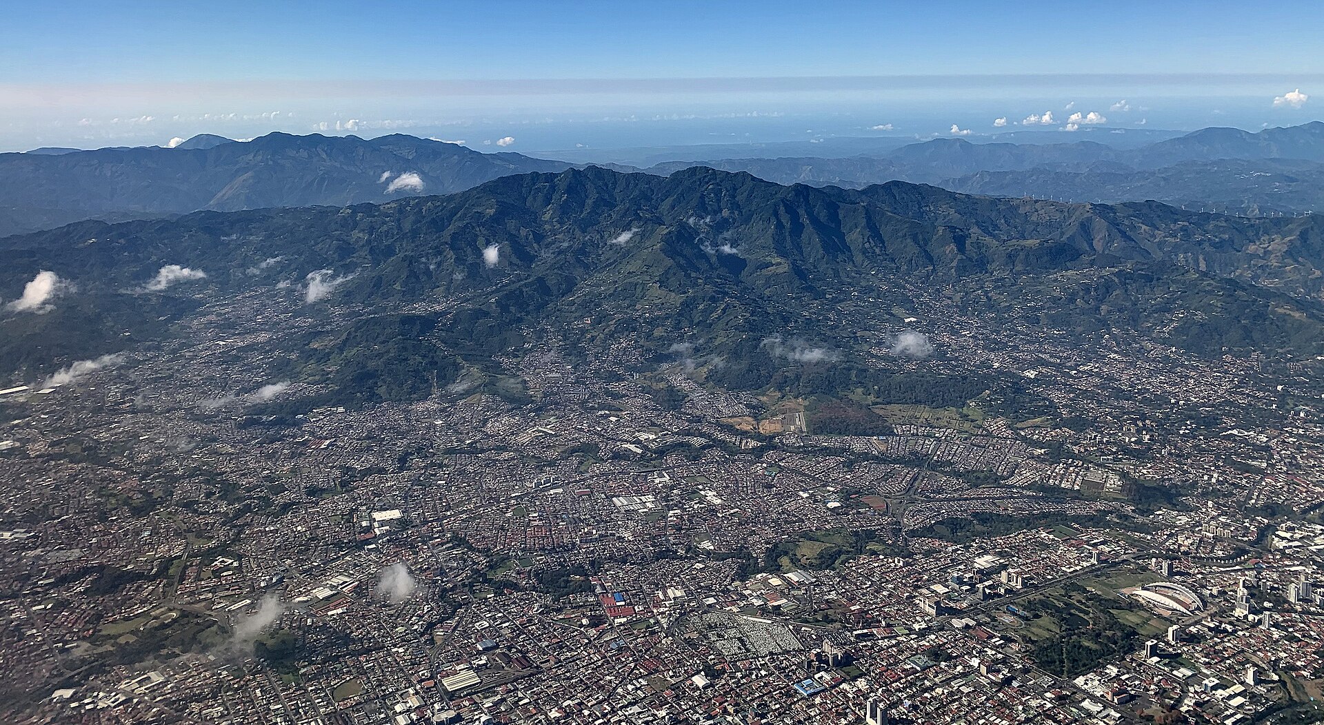 Aerial view of the San José metropolitan area in Costa Rica, with La Sabana park and the Central Valley hills beyond
