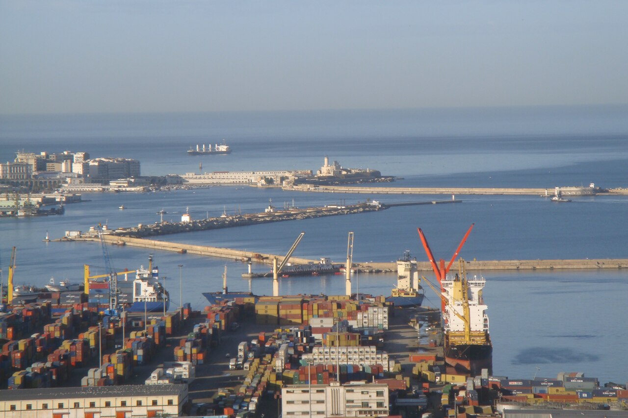 Container terminal and breakwaters of the port of Algiers seen from above, with cargo ships at the quay