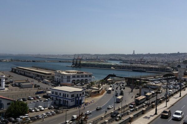 The Port of Algiers with quays, cranes and the waterfront road busy with traffic, seen from above