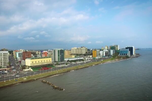 Aerial view of the Libreville seafront in Gabon with office buildings along the coast road and the sea on the right