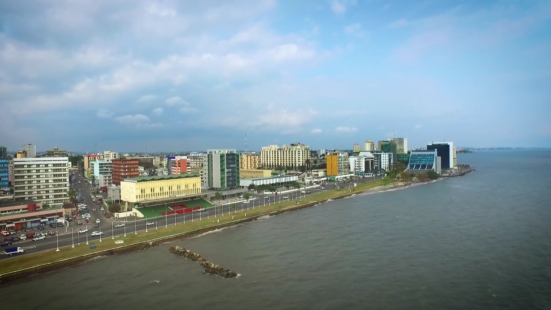 Aerial view of the Libreville seafront in Gabon with office buildings along the coast road and the sea on the right