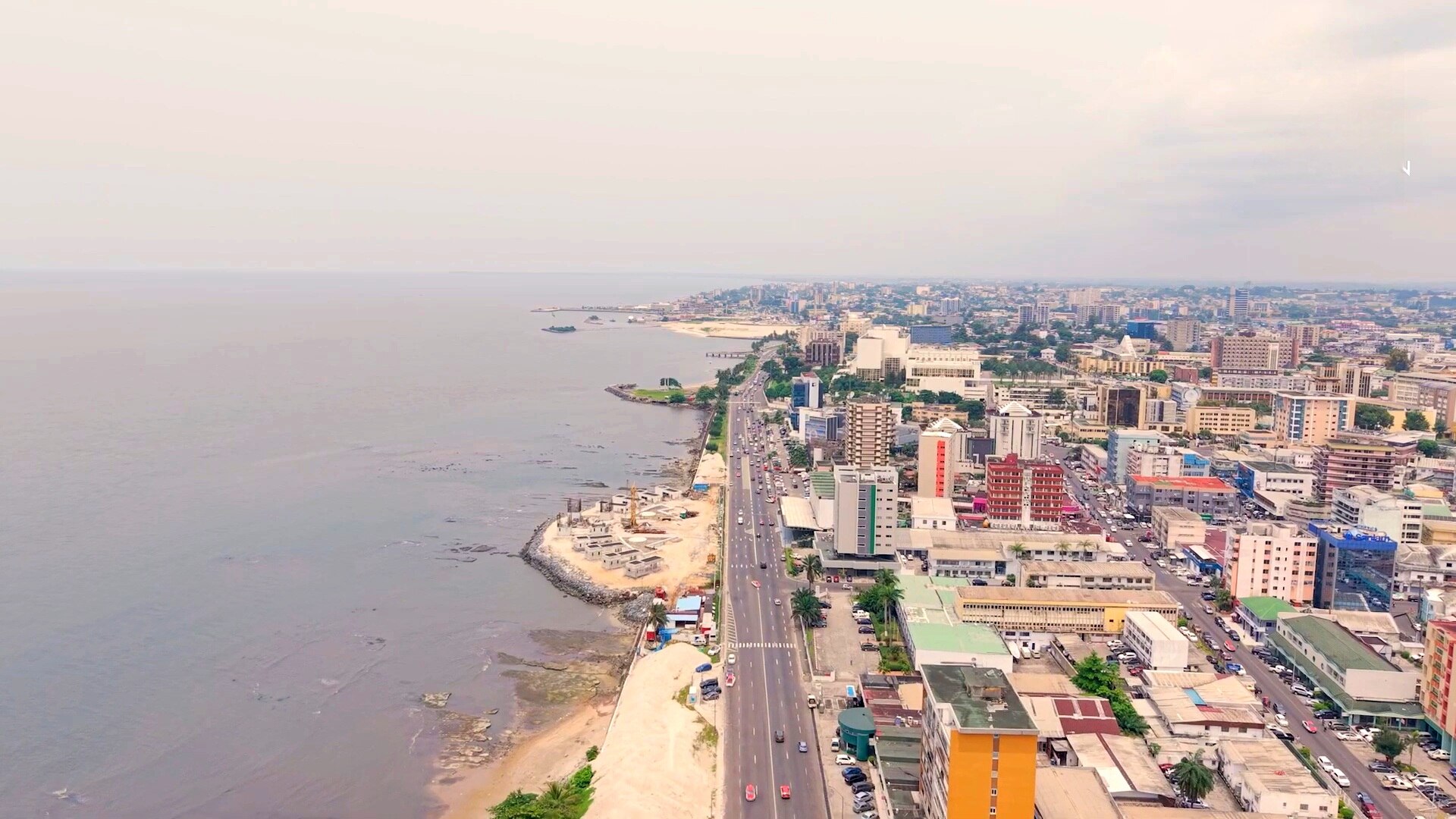 Aerial view of the coast road and city centre of Libreville, Gabon, with the sea on the left