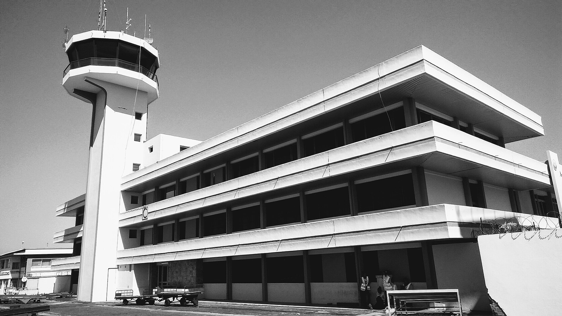 Black and white photo of the control tower and a three-storey terminal block at Ivato International Airport
