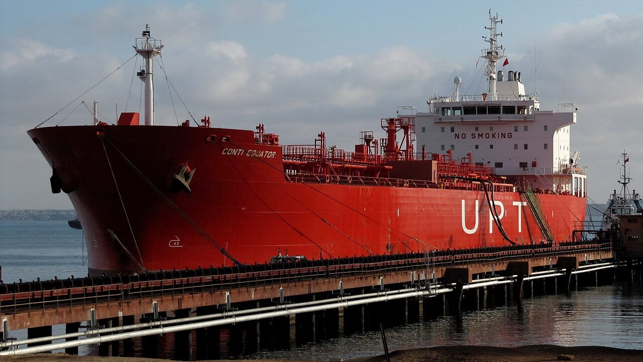 Red ship moored at a jetty in the port of Namibe in Angola