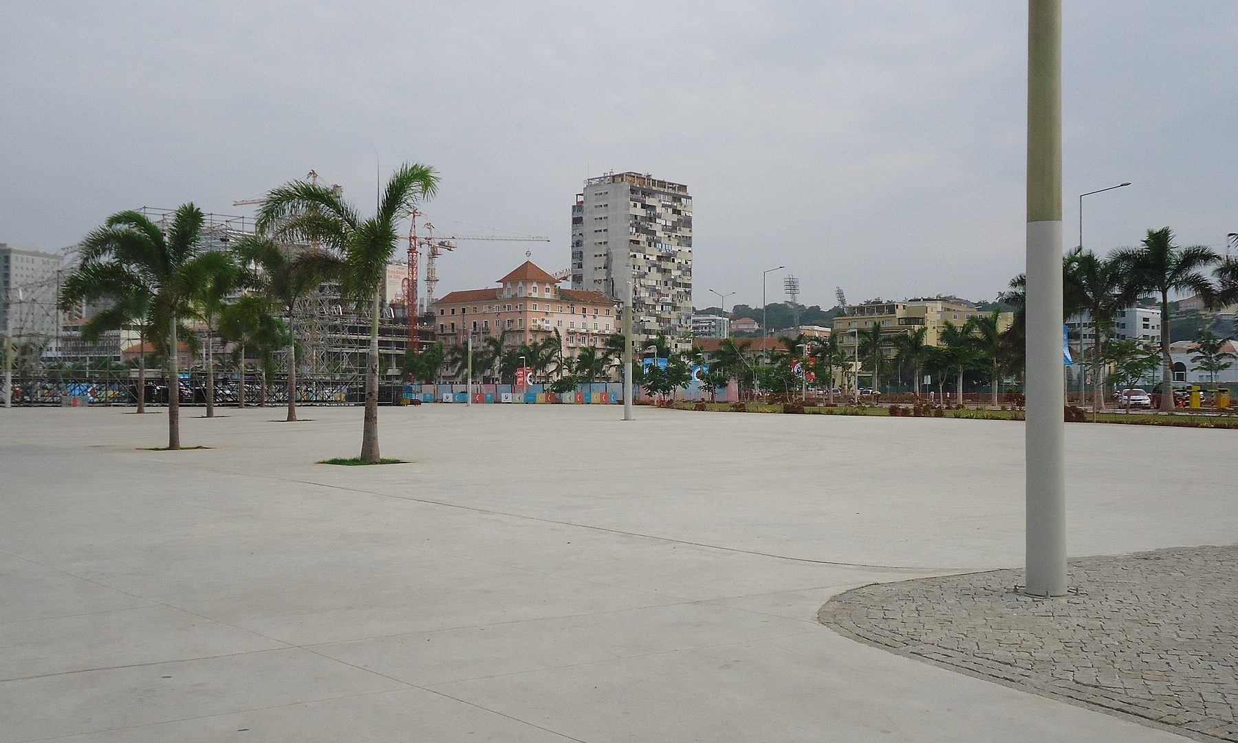 Palm-lined open plaza on the Marginal waterfront in central Luanda, Angola, under a grey sky