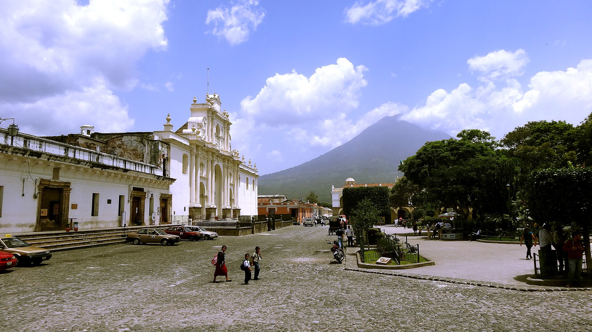 Antigua Guatemala in October: the white facade of the cathedral on the central square, with Volc&aacute;n de Agua behind