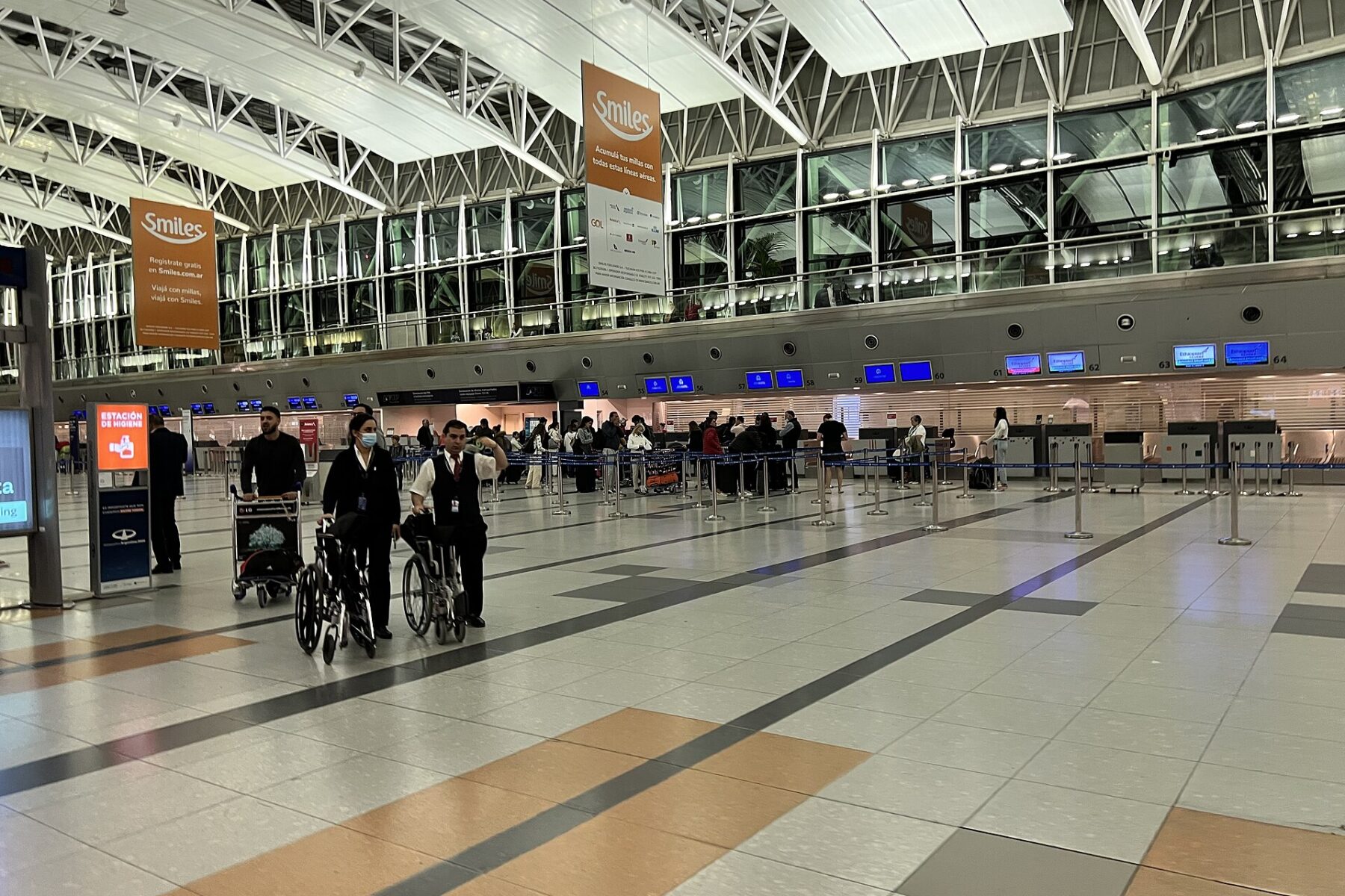 Passengers and check-in counters in the main hall of Ezeiza international airport near Buenos Aires