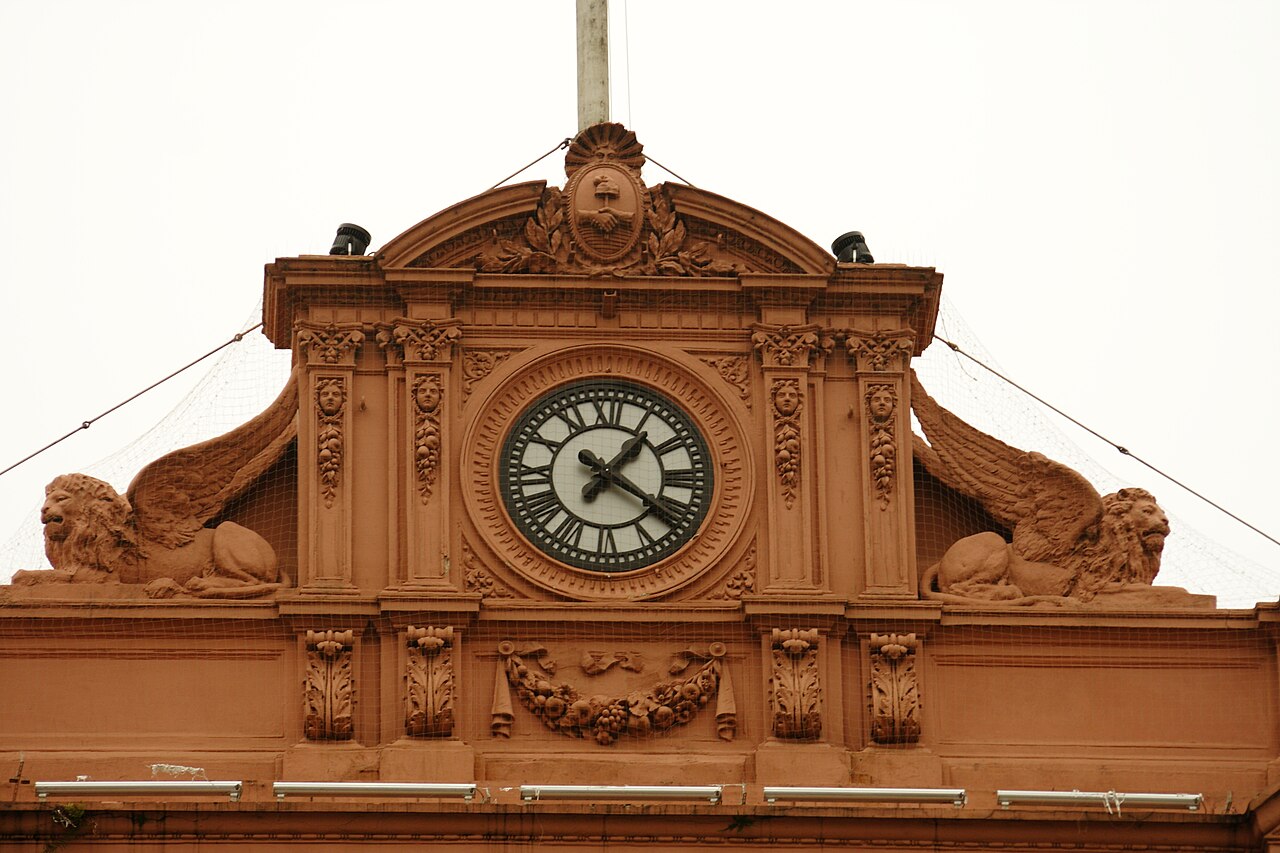 Clock and winged lion sculptures on the terracotta pediment of the Casa Rosada in Buenos Aires