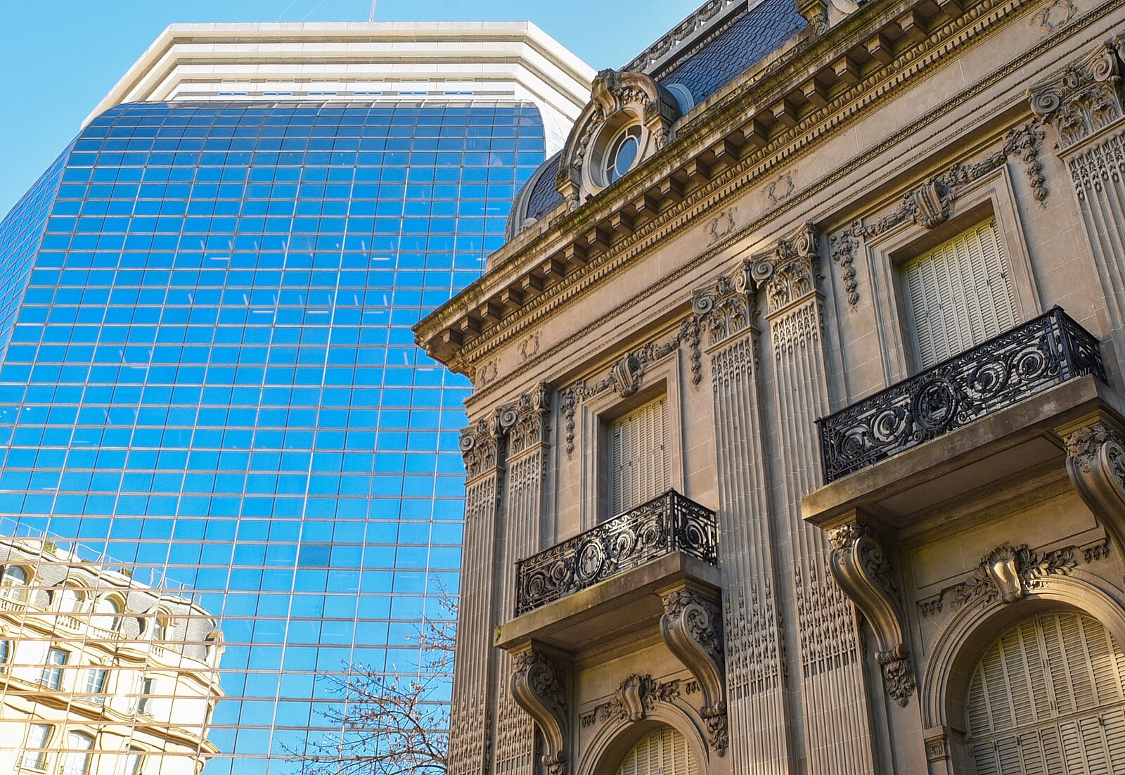 Ornate stone facade of the Palacio San Martín, Argentina's foreign ministry in Buenos Aires, beside a blue glass office tower